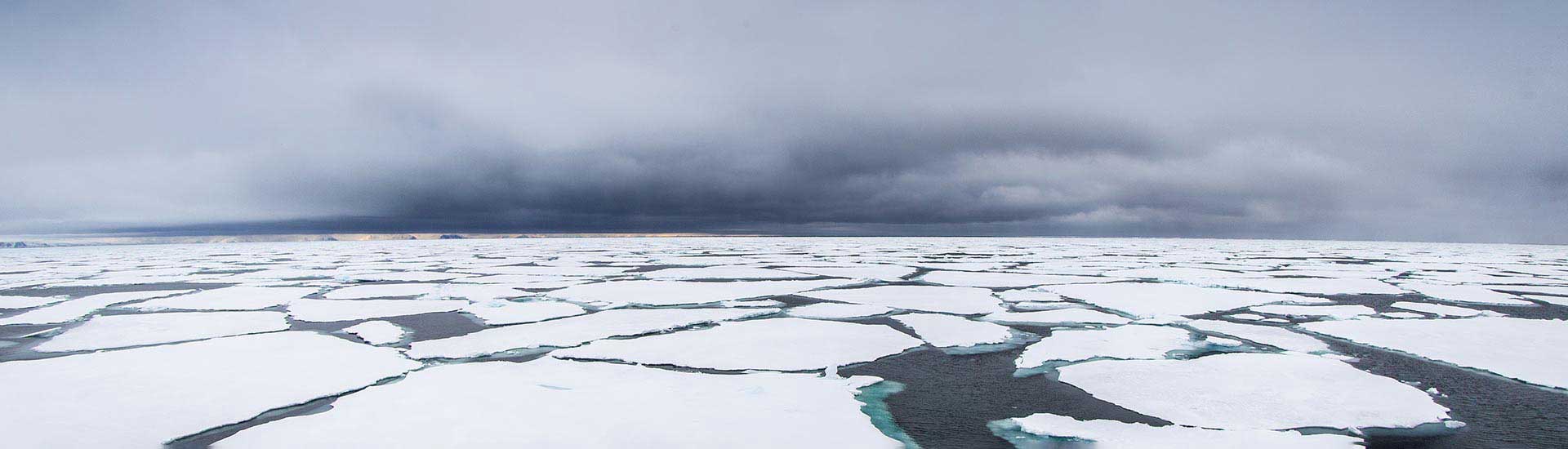 Photo: Sea with ice on top of it in the Artic.