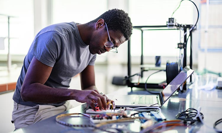 Photo: black engineer working on a tablet